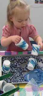 photo of girl playing with beads