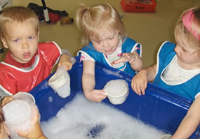 children playing with soapy water