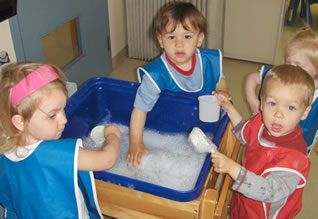 photo of children playing with bubbles in water